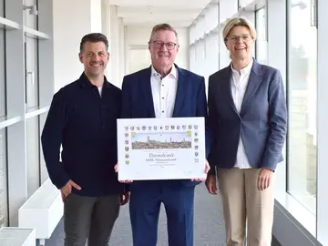 Verleihung der Ehrenurkunde an Bauer für das 235-jährige Firmenjubiläum. 