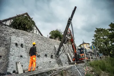 Injection boreholes and masonry nails were installed along with structural reinforcement using self-drilling anchors.